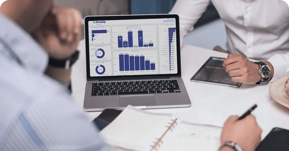 Insurance professionals reviewing LineSlip analytics dashboard with program data and visualizations